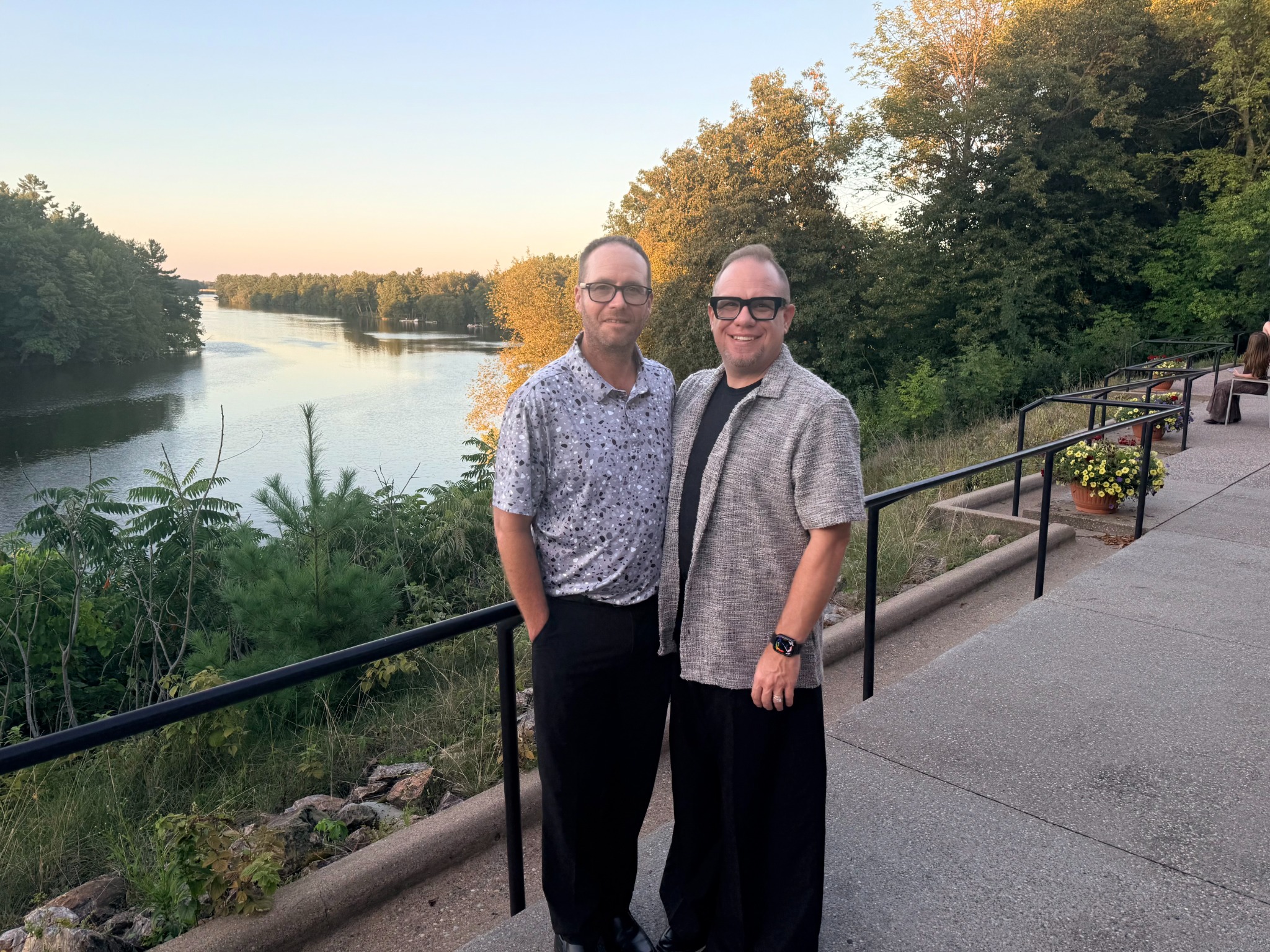 Jess Betts-Nelson and his husband Dusty together overlooking the water